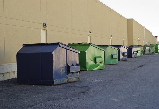 a stack of yellow construction dumpsters on a job site in Canton